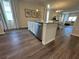 Kitchen island with seating and stainless steel dishwasher at 2523 Avalon Park Blvd, Tavares, FL 32778