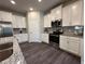 Kitchen with stainless steel appliances and white cabinets at 2523 Avalon Park Blvd, Tavares, FL 32778