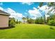 Spacious backyard with lush grass and lake views at 2682 Wyndsor Oaks Pl, Winter Haven, FL 33884