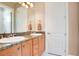 Double vanity bathroom with granite countertop and wood cabinets at 2682 Wyndsor Oaks Pl, Winter Haven, FL 33884