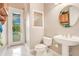 Small bathroom with pedestal sink, toilet and shower at 2682 Wyndsor Oaks Pl, Winter Haven, FL 33884