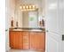 Double vanity bathroom with granite countertop and wood cabinets at 2682 Wyndsor Oaks Pl, Winter Haven, FL 33884