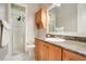 Bathroom with granite countertop, wood cabinets and shower stall at 2682 Wyndsor Oaks Pl, Winter Haven, FL 33884