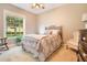 Bright bedroom with a queen-size bed and rocking chair at 2682 Wyndsor Oaks Pl, Winter Haven, FL 33884