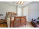 Bedroom with a wooden bed frame and leather chair at 2682 Wyndsor Oaks Pl, Winter Haven, FL 33884