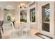 Bright breakfast nook with white table and chairs, adjacent to kitchen at 2682 Wyndsor Oaks Pl, Winter Haven, FL 33884