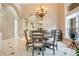 Formal dining room with a round table and chandelier at 2682 Wyndsor Oaks Pl, Winter Haven, FL 33884