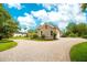 Large brick driveway leading to a three-car garage at 2682 Wyndsor Oaks Pl, Winter Haven, FL 33884