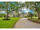 Two-story house with a large driveway and lush landscaping at 2682 Wyndsor Oaks Pl, Winter Haven, FL 33884