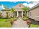 Inviting front entrance with a brick walkway and lush landscaping at 2682 Wyndsor Oaks Pl, Winter Haven, FL 33884