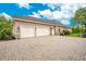 Three-car garage with brick paved driveway at 2682 Wyndsor Oaks Pl, Winter Haven, FL 33884