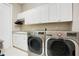 Laundry room with white cabinets, granite countertop and LG washer/dryer at 2682 Wyndsor Oaks Pl, Winter Haven, FL 33884