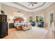 Luxurious main bedroom with wood flooring, a king-size bed, and ample natural light at 2682 Wyndsor Oaks Pl, Winter Haven, FL 33884