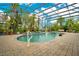 Screened pool area with brick pavers and lush landscaping at 2682 Wyndsor Oaks Pl, Winter Haven, FL 33884