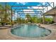 Relaxing pool area with a screened enclosure and brick patio at 2682 Wyndsor Oaks Pl, Winter Haven, FL 33884