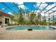 Screened pool and spa with brick pavers and lush landscaping at 2682 Wyndsor Oaks Pl, Winter Haven, FL 33884