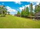 Expansive lawn leads to private dock and canal access at 2682 Wyndsor Oaks Pl, Winter Haven, FL 33884