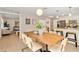 Bright dining room with a long wooden table and modern chairs at 2779 Prince John Rd, Winter Park, FL 32792