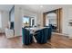 Dining room with a modern table and blue velvet chairs at 2944 Moulin Rd, Davenport, FL 33837