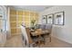 Elegant dining room features a yellow wall and a large wooden table with gray chairs at 2994 Salisbury Ave, Haines City, FL 33844