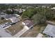 Aerial view of a house with brown roof, driveway, and yard at 3054 Shallowford St, Deltona, FL 32738