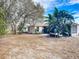 Backyard with tropical plants and partial view of the house at 3054 Shallowford St, Deltona, FL 32738