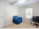 Bedroom with a comfy chair, workspace, and window with blinds at 3054 Shallowford St, Deltona, FL 32738