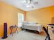 Bright bedroom with a bed, workspace, and ceiling fan at 3054 Shallowford St, Deltona, FL 32738