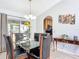 Dining room with glass-top table, six chairs, and access to the kitchen at 3054 Shallowford St, Deltona, FL 32738