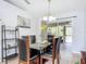 Bright dining room features a glass-top table with six chairs and sliding glass doors to backyard at 3054 Shallowford St, Deltona, FL 32738