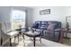 Living room featuring a brown leather sofa, coffee table, and armchair at 3054 Shallowford St, Deltona, FL 32738