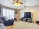 Relaxing living room with comfortable seating, large TV, and ceiling fan at 3054 Shallowford St, Deltona, FL 32738