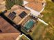 Aerial view showcasing a house with solar panels and a screened pool at 308 Willowbay Ridge St, Sanford, FL 32771