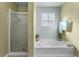 Bathroom with shower, bathtub, and window at 308 Willowbay Ridge St, Sanford, FL 32771