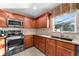 Bright kitchen with stainless steel appliances and wood cabinets at 308 Willowbay Ridge St, Sanford, FL 32771