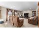 Cozy living room with brown leather couches, a large TV, and ample natural light at 308 Willowbay Ridge St, Sanford, FL 32771