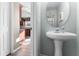 Convenient half-bath with pedestal sink and mirror at 308 Willowbay Ridge St, Sanford, FL 32771