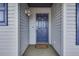 Inviting front entrance with a blue door and welcome mat at 313 Dirksen Dr # B16, Debary, FL 32713