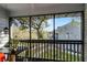 Relaxing screened porch overlooking a tree and neighboring building at 313 Dirksen Dr # B16, Debary, FL 32713