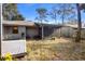 Backyard with screened patio, deck, and grassy area at 360 Gleneagles Dr, New Smyrna Beach, FL 32168