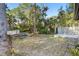 Backyard with wooden planter box and small blue bench at 360 Gleneagles Dr, New Smyrna Beach, FL 32168