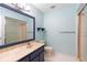 Clean bathroom with blue vanity, large mirror and shower/tub combo at 360 Gleneagles Dr, New Smyrna Beach, FL 32168