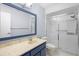 Bathroom with blue vanity, large mirror, and shower stall at 360 Gleneagles Dr, New Smyrna Beach, FL 32168