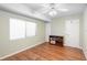 Spacious bedroom with hardwood floors and ceiling fan at 360 Gleneagles Dr, New Smyrna Beach, FL 32168