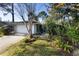 Single-story home with a one-car garage and landscaped yard at 360 Gleneagles Dr, New Smyrna Beach, FL 32168