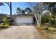 Single-story house with attached garage and landscaping at 360 Gleneagles Dr, New Smyrna Beach, FL 32168