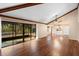 Bright living room featuring hardwood floors and sliding glass doors leading to the outdoors at 360 Gleneagles Dr, New Smyrna Beach, FL 32168