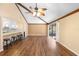 Bright living room with hardwood floors, vaulted ceiling and sliding glass doors at 360 Gleneagles Dr, New Smyrna Beach, FL 32168