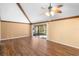 Living room with hardwood floors, vaulted ceiling and access to screened porch at 360 Gleneagles Dr, New Smyrna Beach, FL 32168