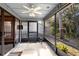 Screened porch with wood-look tile floor and view of backyard at 360 Gleneagles Dr, New Smyrna Beach, FL 32168